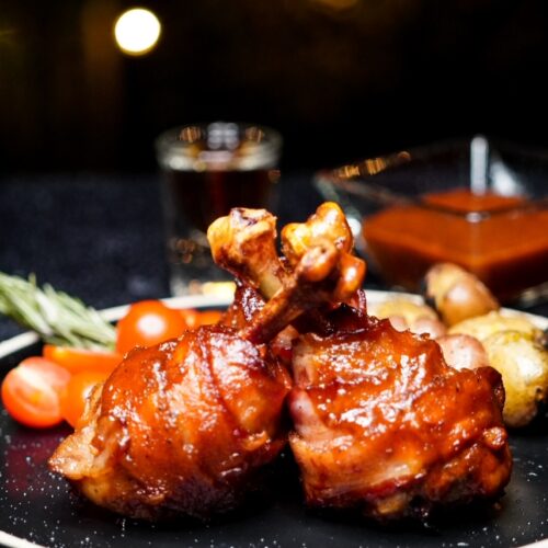 Bacon-wrapped Bourbon Honey Glazed Chicken Lollipops | Wild West Viking